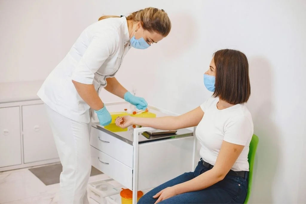 A certified medical professional preparing a sterile IV drip, representing safety standards for IV therapy providers in Bali.